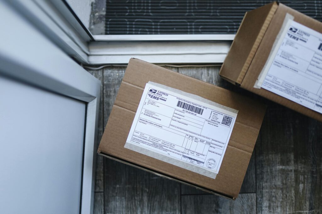 Delivery of a cardboard box package to the doorstep